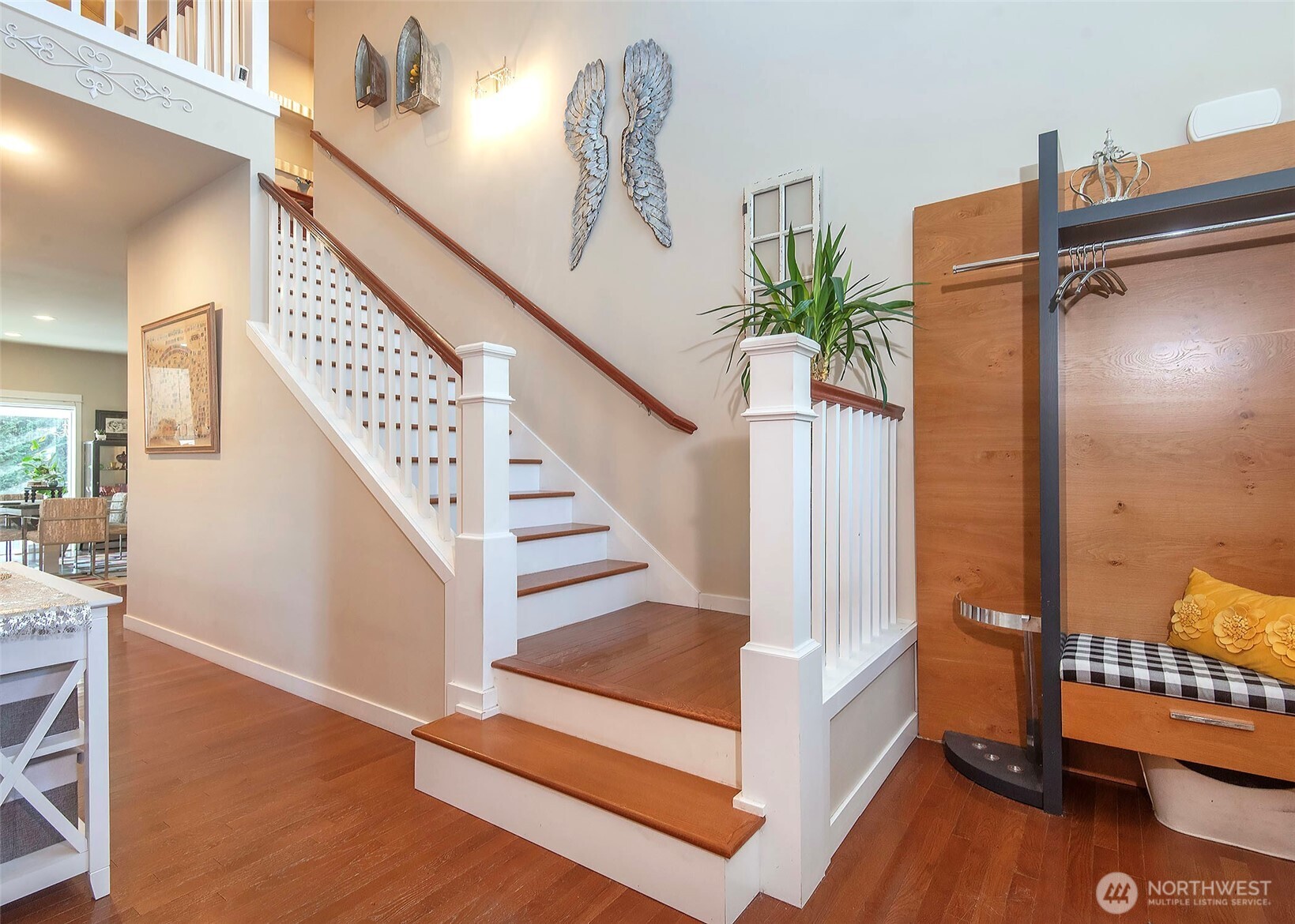 Front entry highlighted by a classic wood staircase