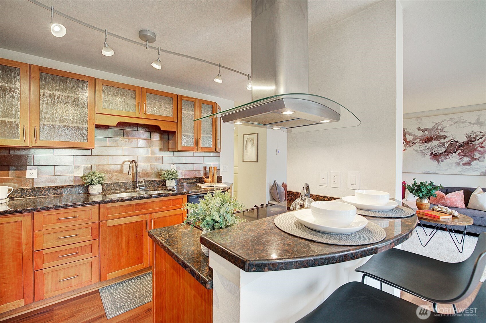 The dining room view overlooks the tree lined scenery surrounding this home.
