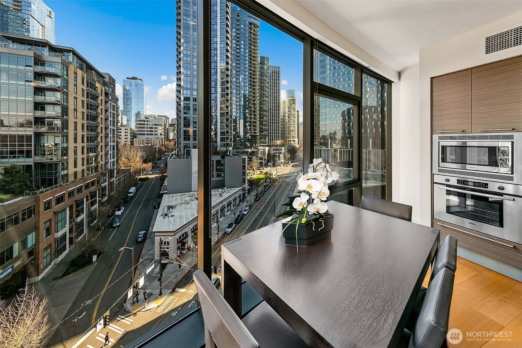 The SE corner curved window wall creates a functional dining space with a view.