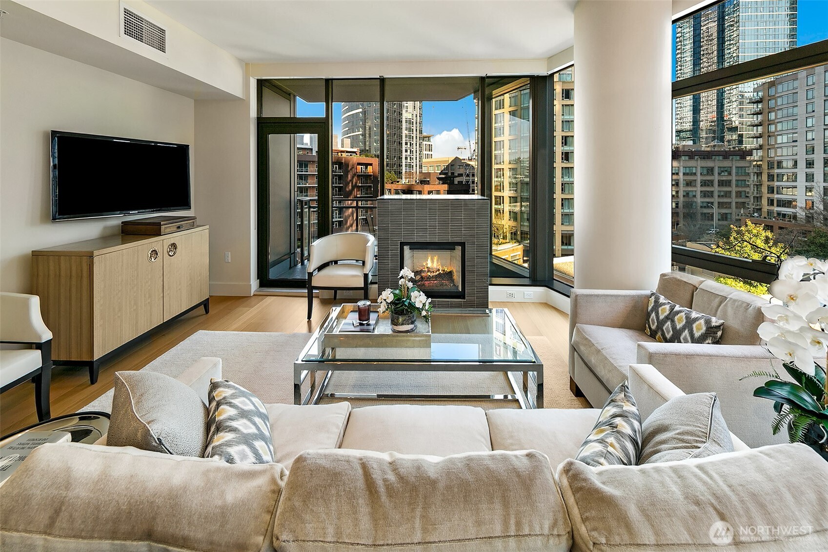 Cozy gas fireplace anchors the living room, but does not distract from the floor to ceiling window wall views.