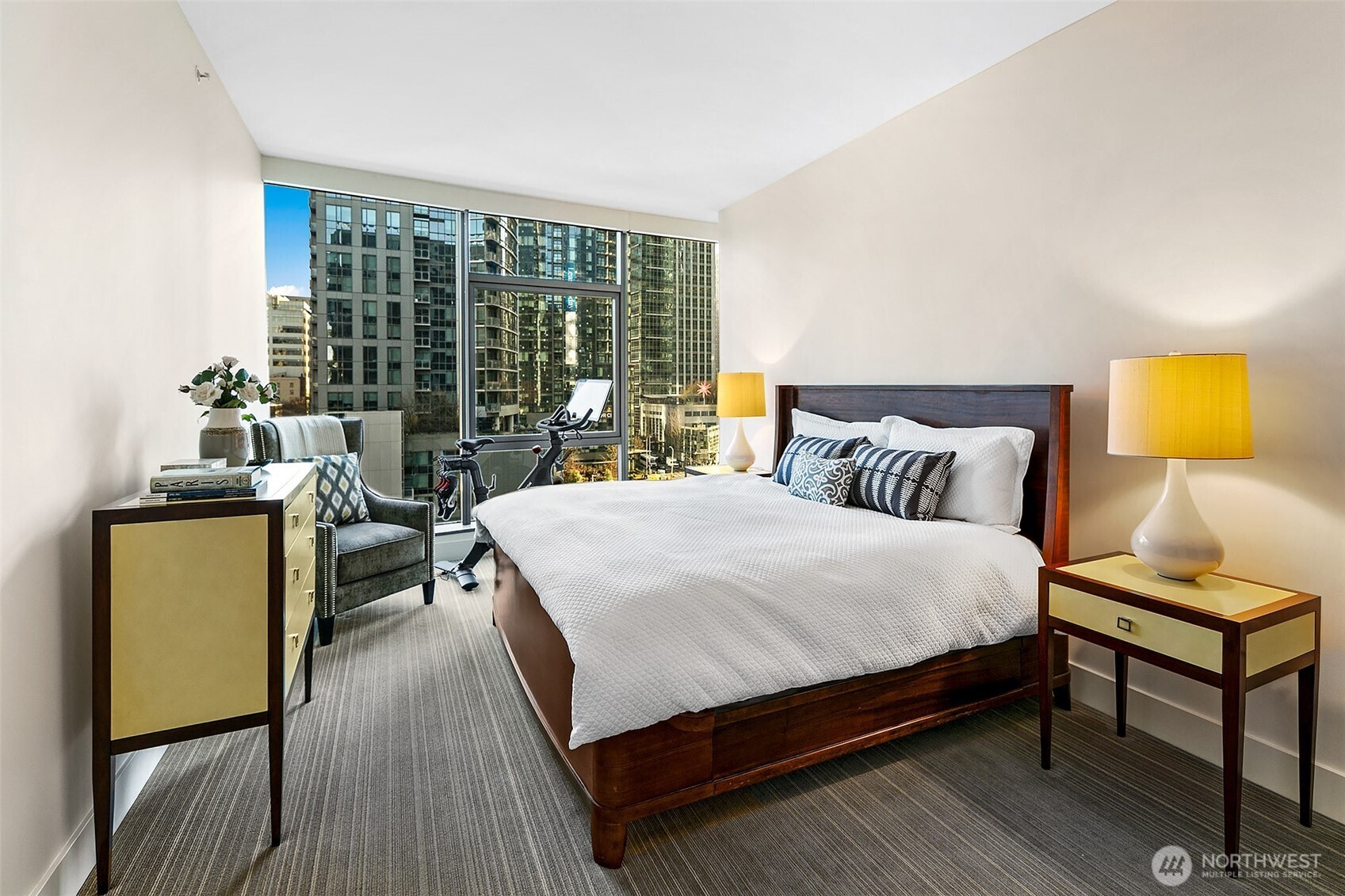 Primary bedroom fit for a king size bed with room to move (or exercise) too.