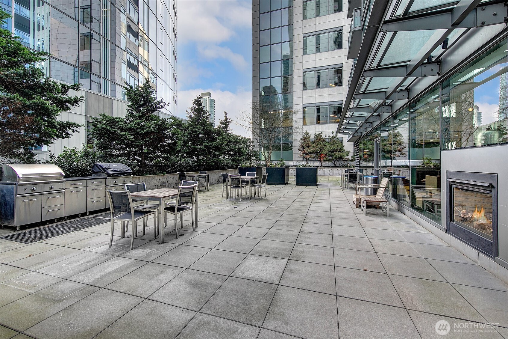 Resident sundeck with multiple barbecue grills, dining tables and chairs for outdoor enjoyment.