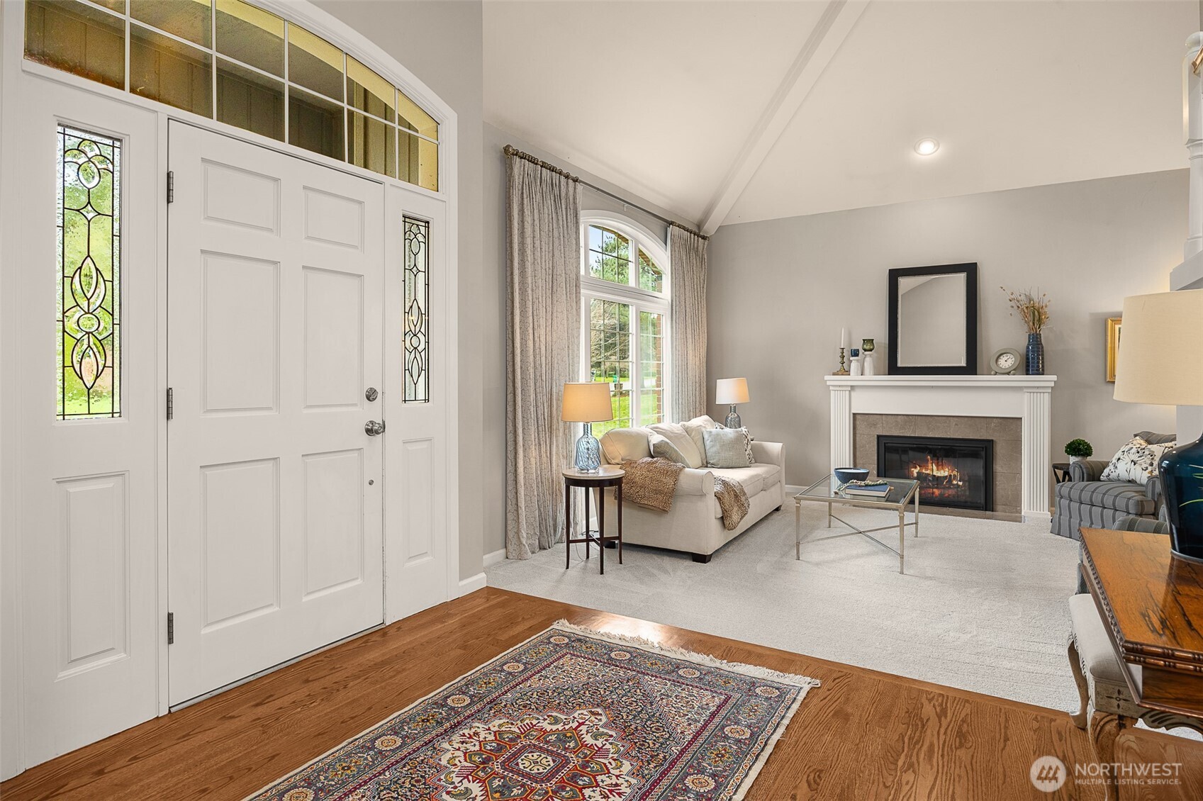 A welcoming formal living room w/ gas fireplace awaits just beyond the grand foyer