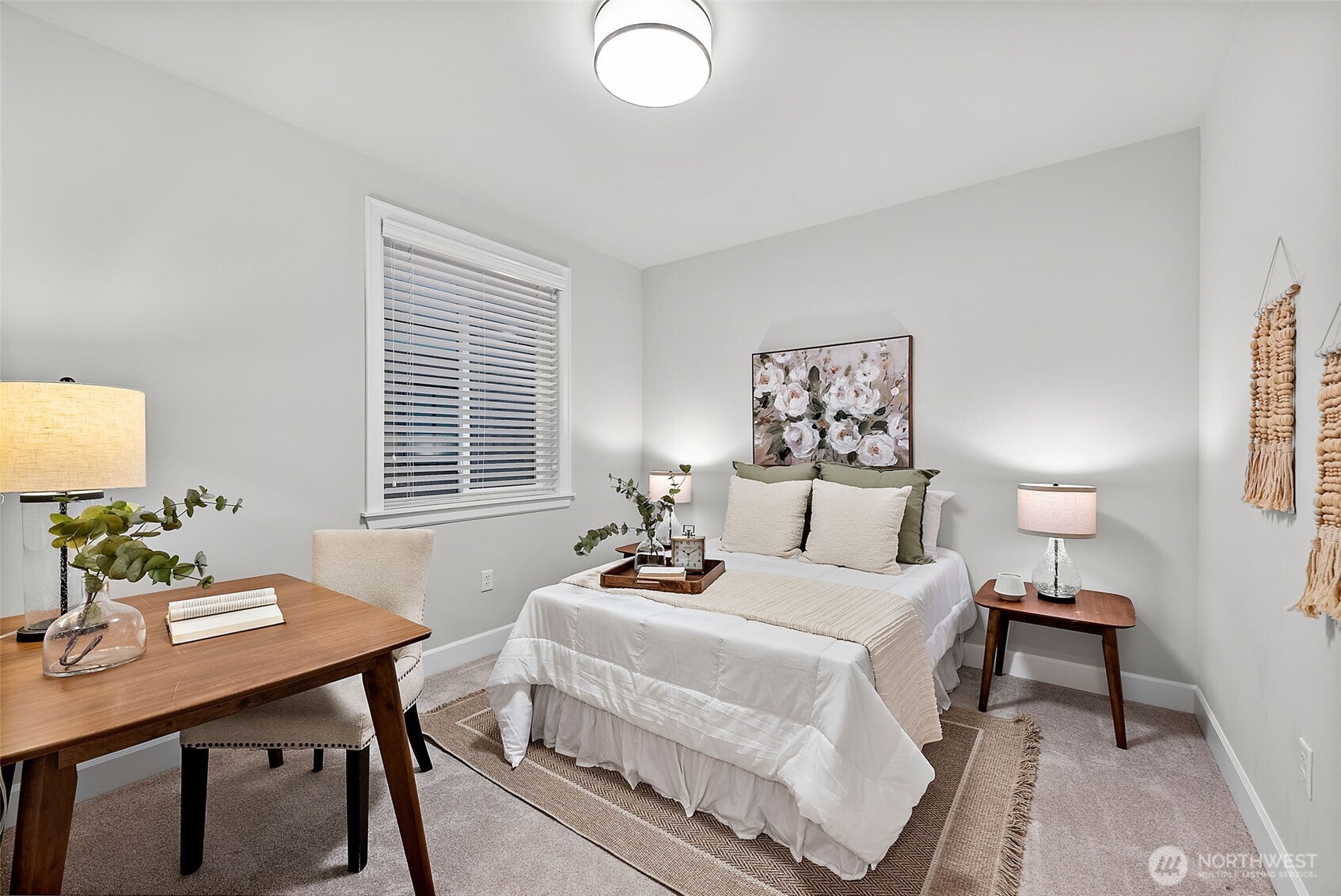 Second bedroom with carpeted floors and overhead light.