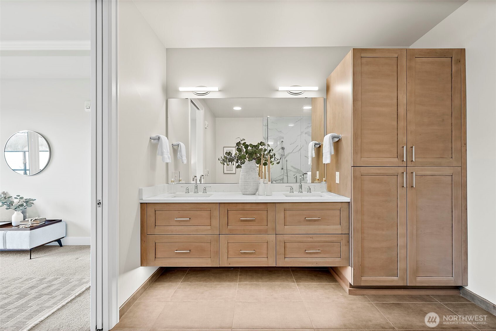 Primary en-suite bath vanity with storage with under vanity lighting as well as behind mirror lighting