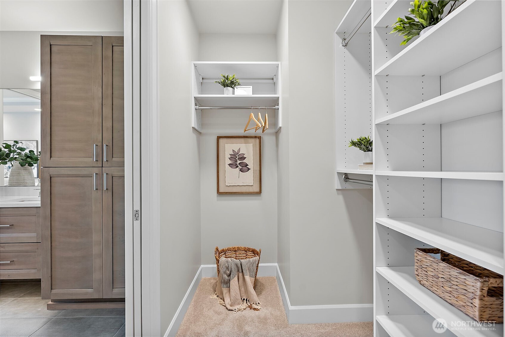 Primary Walk-in closet - left side nook, carpeted flooring throughout closet.