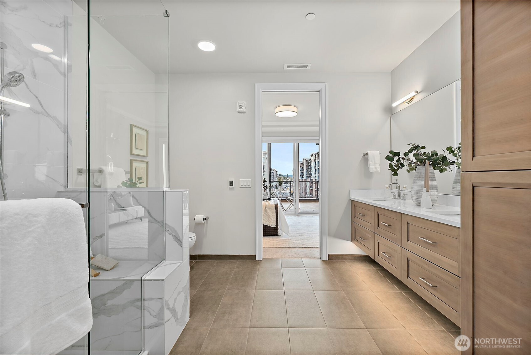 Large bathroom from primary suite even captures the Village view from standing in front of the walk-in closet