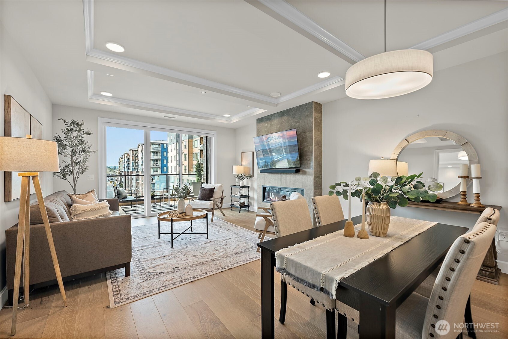 Pendent lighting fixture hangs over dining area between living room and kitchen.