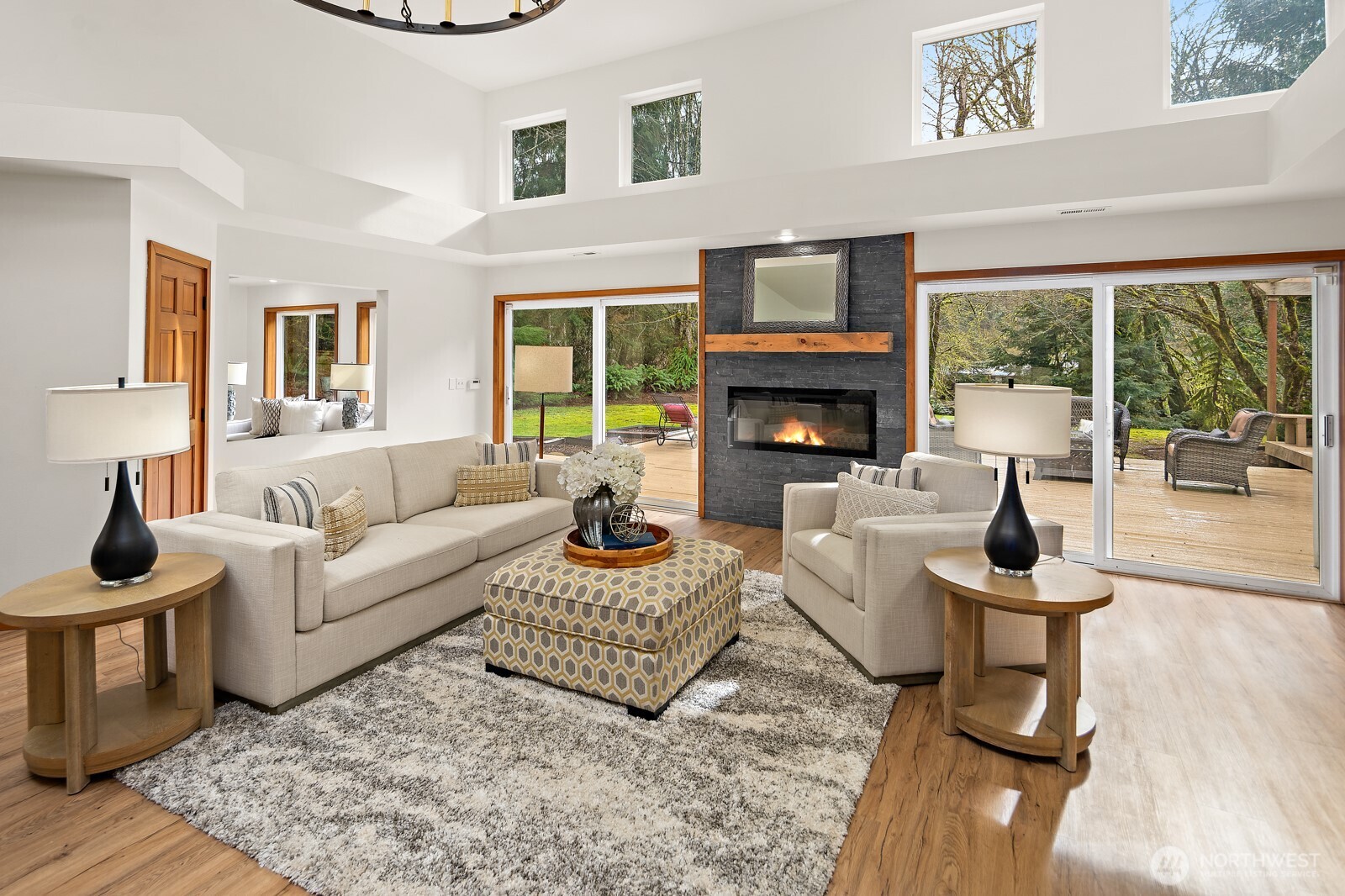 A beautiful stone fireplace sets the stage in the living room and large sliders open to the gorgeous back deck.