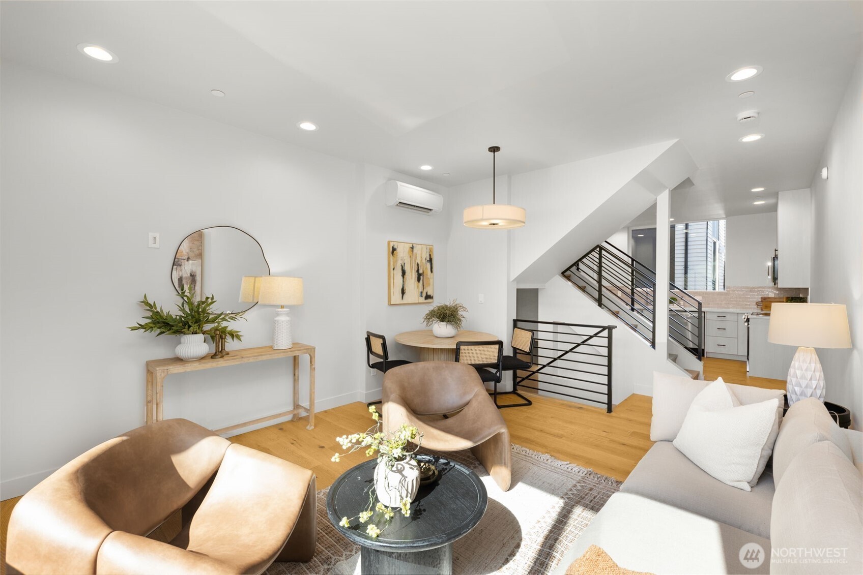 Open-concept layout designed for modern living, boasting designer lighting, rich hardwood floors, and seamless flow between spaces