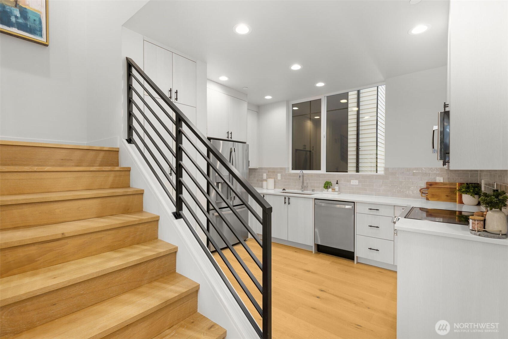 Architectural staircase serves as a functional piece of art, connecting the light-filled levels of this thoughtfully designed home
