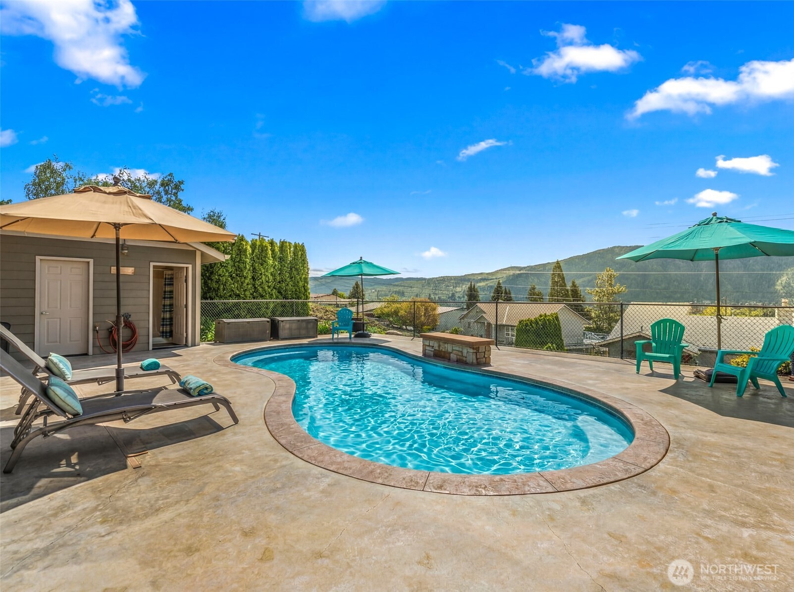 Salt water pool with water feature and pool house.