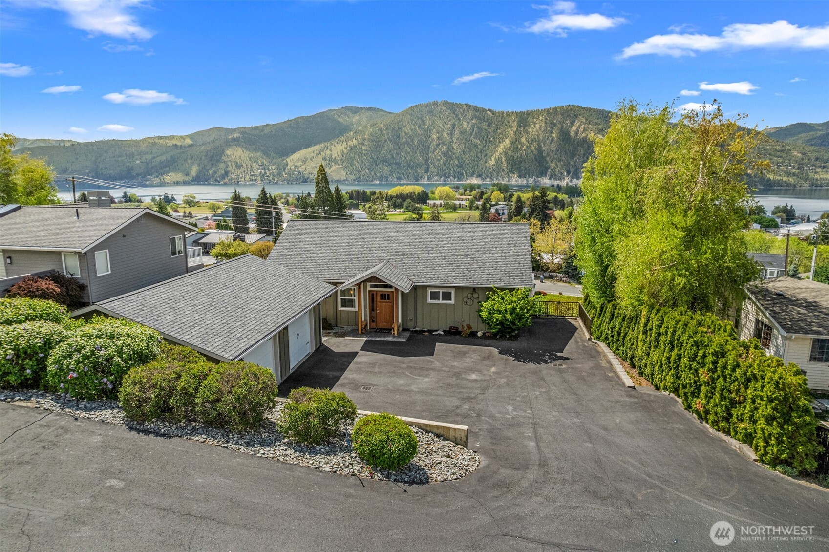 Two car garage with parking for guests and a boat.