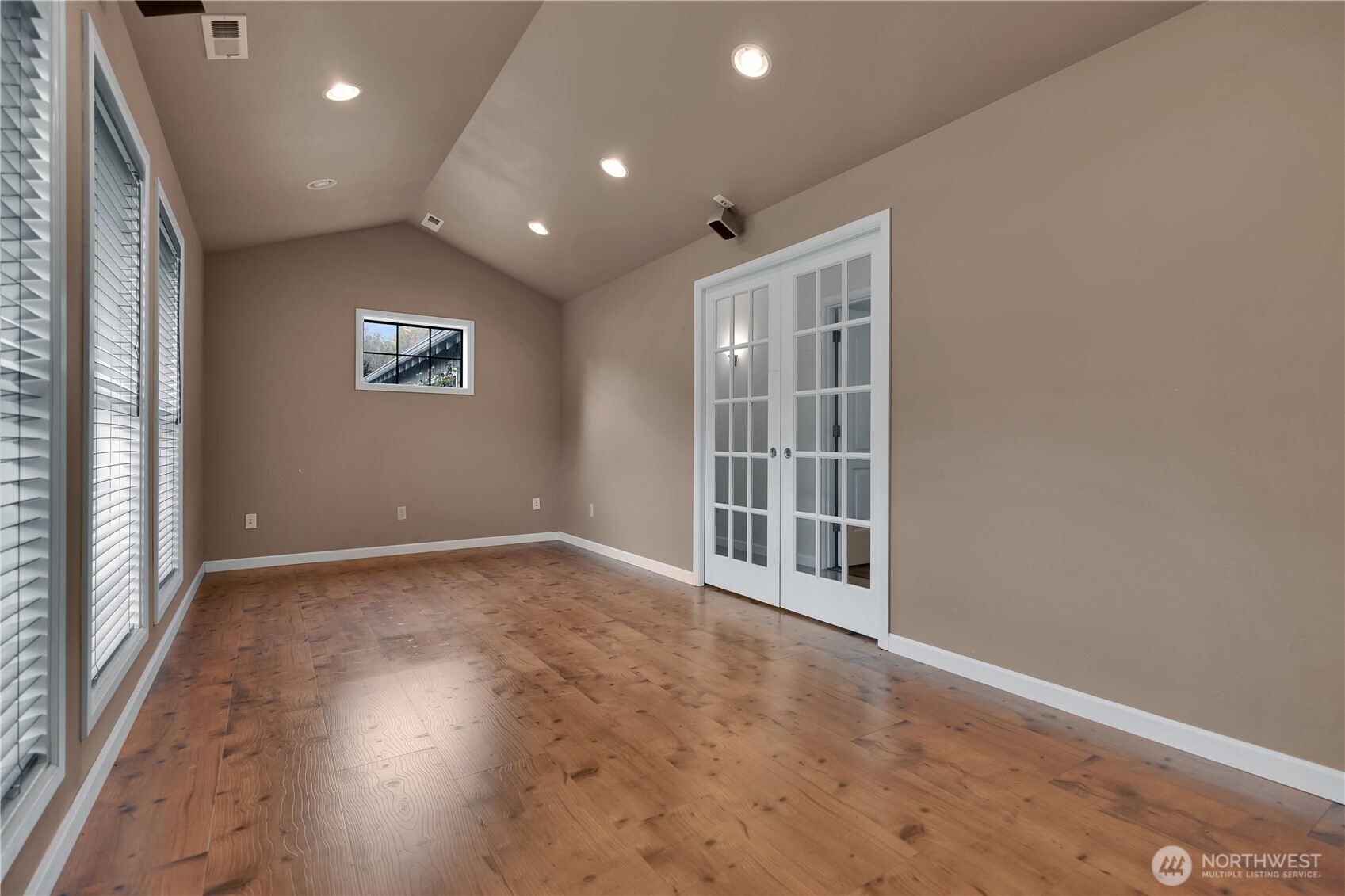 Light filled space with French doors and a row of windows offers flexible options.