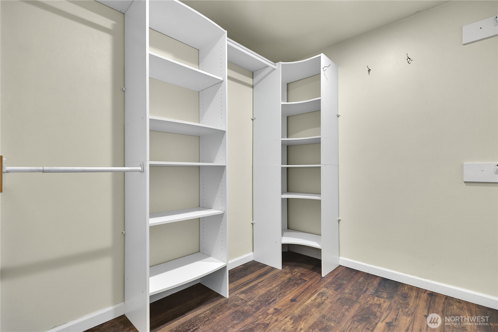 Spacious primary closet with custom built-ins for your organizing needs.