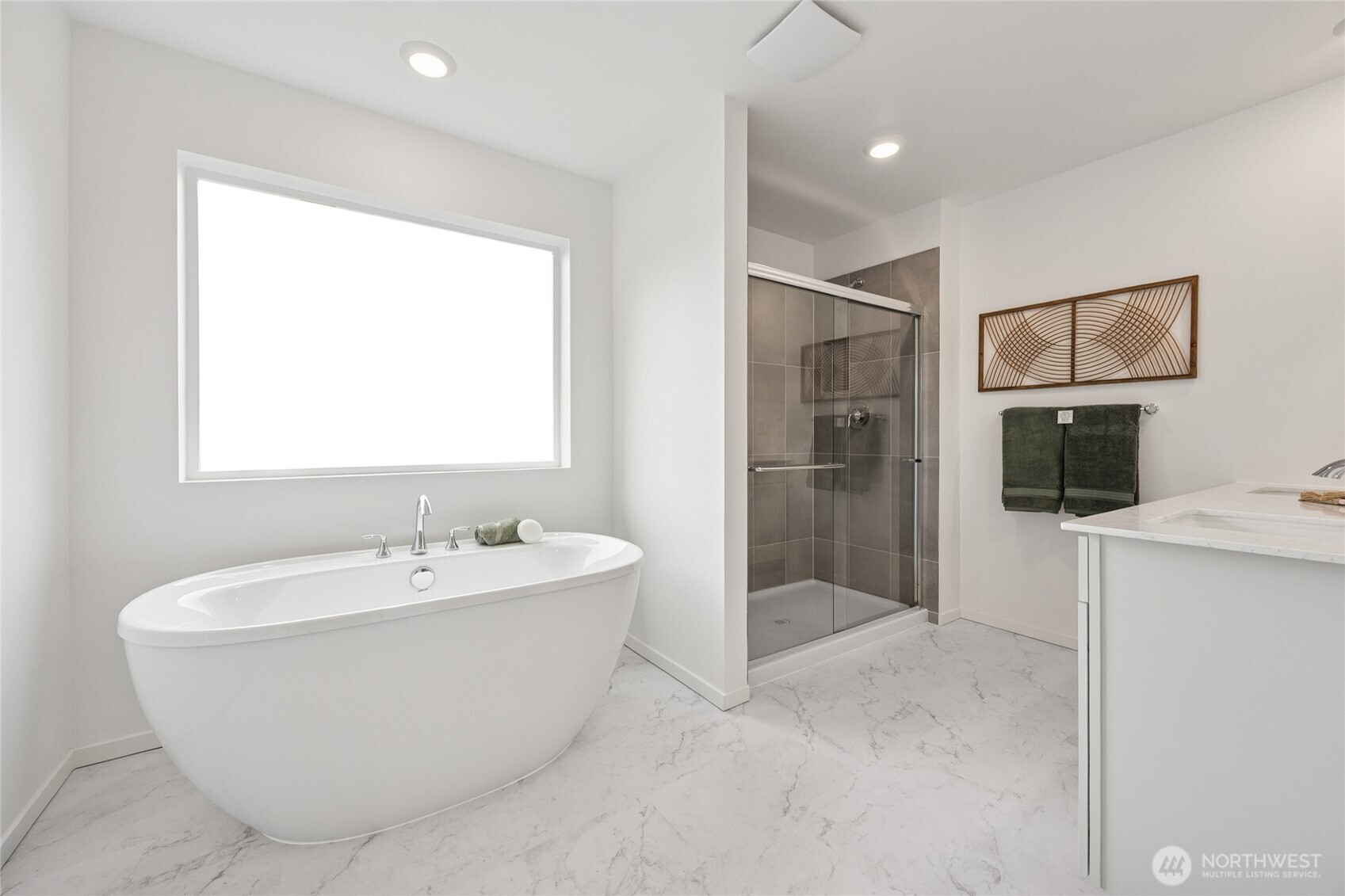 Primary bathroom with a spa-inspired soaking tub, dual vanities, tile shower, separate toilet room, and walk-in closet.  Picture for representational purposes only, colors and features may vary.