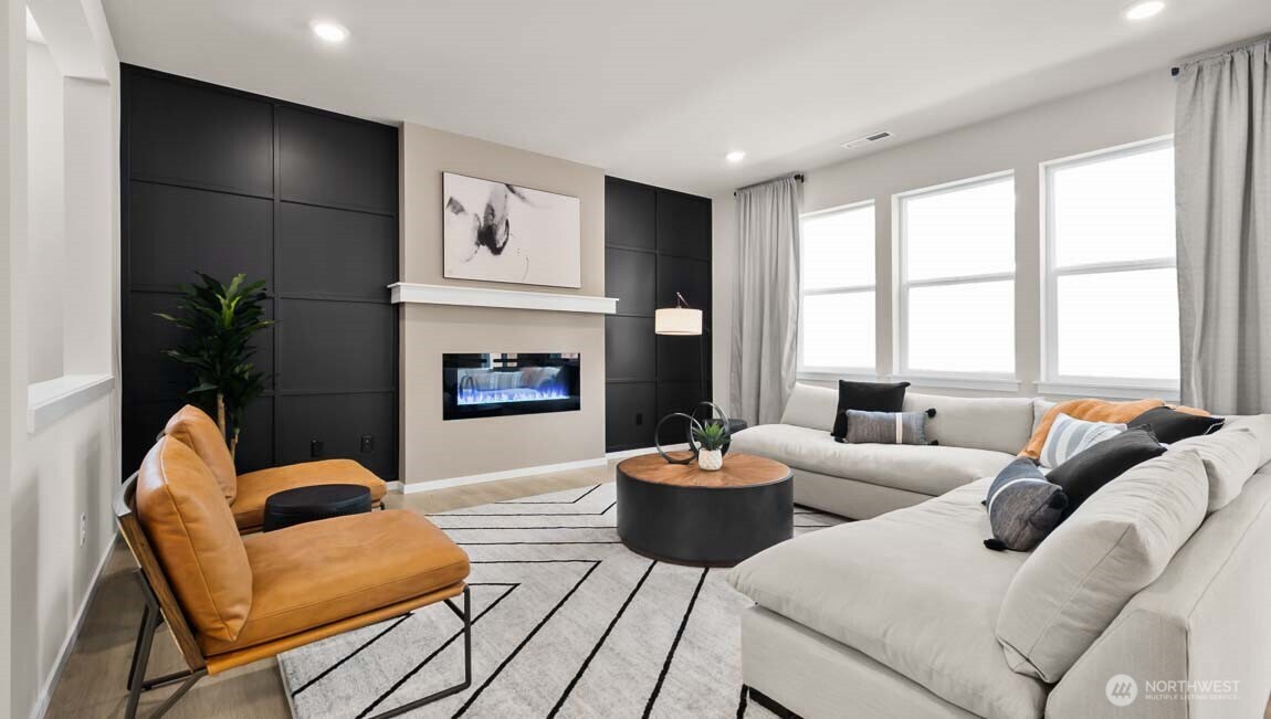 Spacious family room with electric fireplace, wired for TV above the mantel, and tremendous sunlight!  Picture for representational purposes only, colors and features may vary.