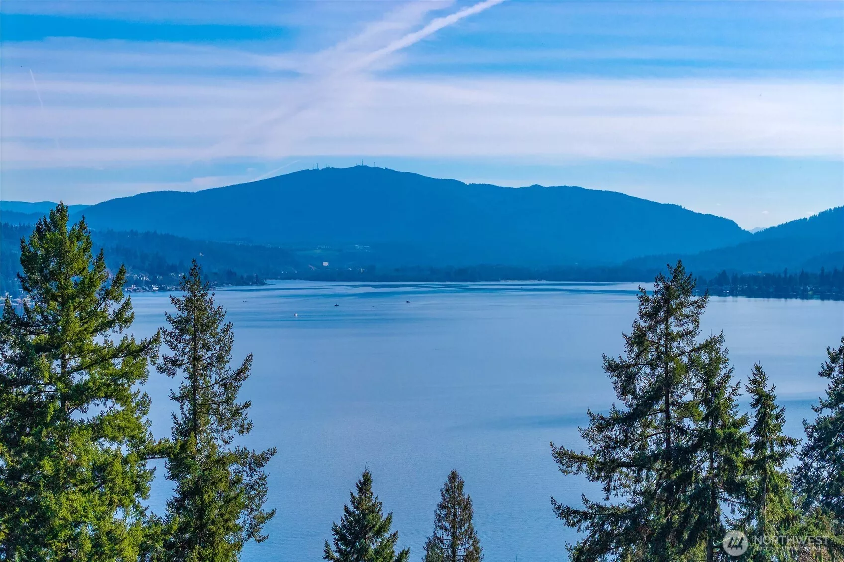 Sweeping Lake & mountain views set on a shy acre lot in an exclusive enclave of just 7 luxury homes in Bellevue