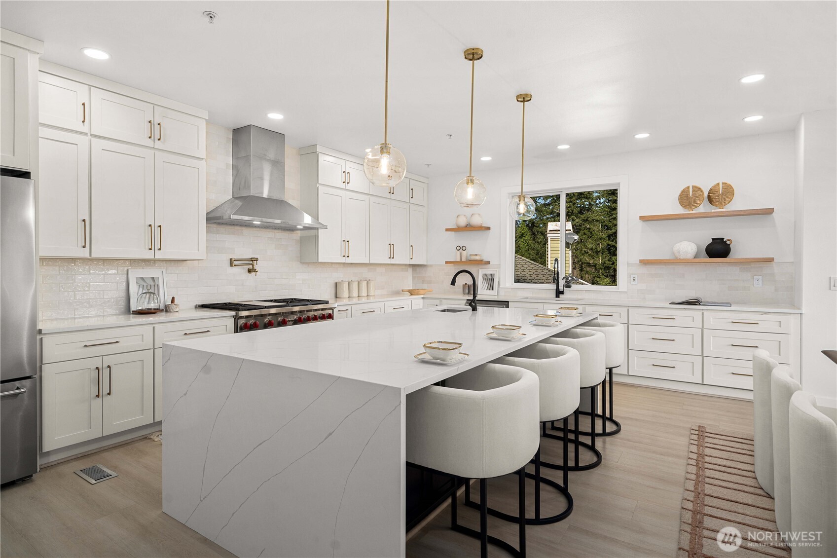 Oversized marble waterfall island designed for elevated entertaining & daily living