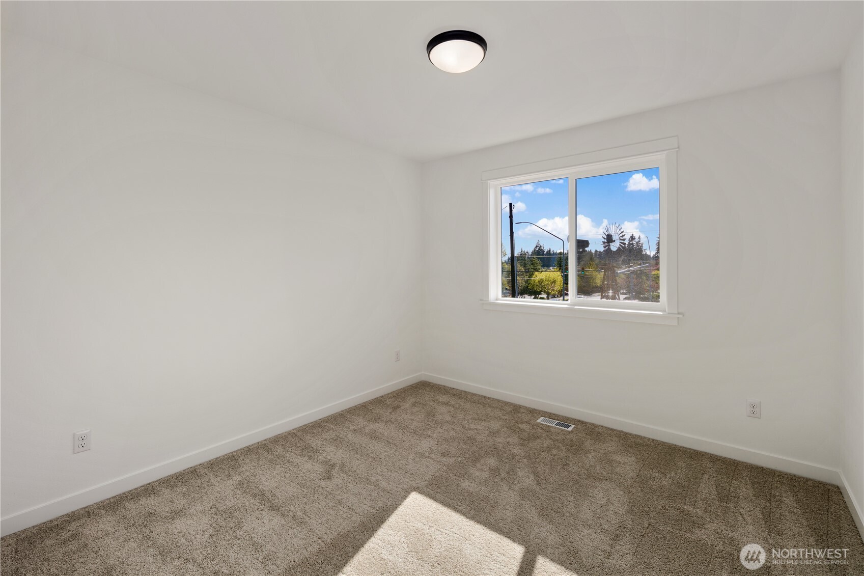 Secondary Bedroom Three  This right-sized upper level bedroom offers a comfortable footprint with clean lines and soft carpeting underfoot. A large window brings in natural light, creating a bright and functional space suited for a guest room, home office, or secondary bedroom. Neutral finishes provide a versatile backdrop for a variety of furniture layouts.    Located in Bothell’s Canyon Park area, this adaptable bedroom reflects the thoughtful design found in modern new construction homes served by the Northshore School District.    These photos are from a past Robinson Plan at a different community, so overall plan, colors, building orientation, finishes, home outlook, and other details can and WILL vary. All photos, renderings, site maps, and floorplans are for visualization purposes only.