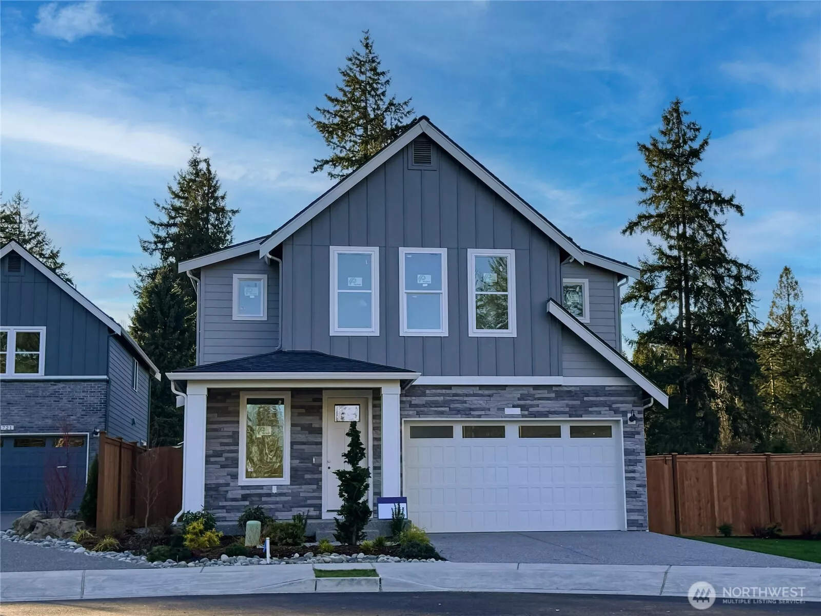 Exterior | Homesite 4  The Robinson plan on Homesite 4 presents clean Pacific Northwest contemporary lines with a balanced mix of vertical siding and stone accents. Large upper-level windows introduce natural light, while the covered entry creates a defined and welcoming approach. The streamlined façade reflects the architectural character associated with modern luxury new construction.    Located in Bothell’s Canyon Park neighborhood, this thoughtfully designed home is currently under construction. Garage and front door colors are subject to change as selections are finalized. The residence reflects the quality and craftsmanship expected in new construction homes served by the Northshore School District.    All photos, renderings, site maps, and floorplans are for visualization purposes only.