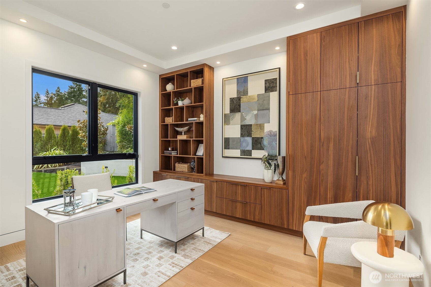 A handsome home office with custom built-in cabinetry offers the perfect work-from-home retreat.