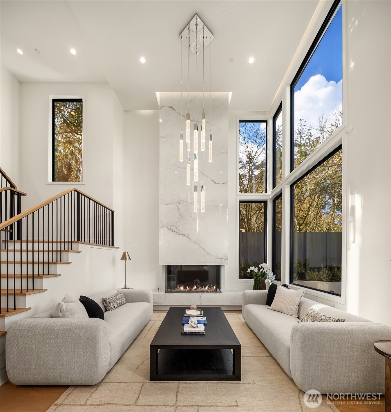 A grand two-story entry sets the tone with soaring ceilings and a striking DaVinci fireplace — an artful welcome that instantly feels like home.