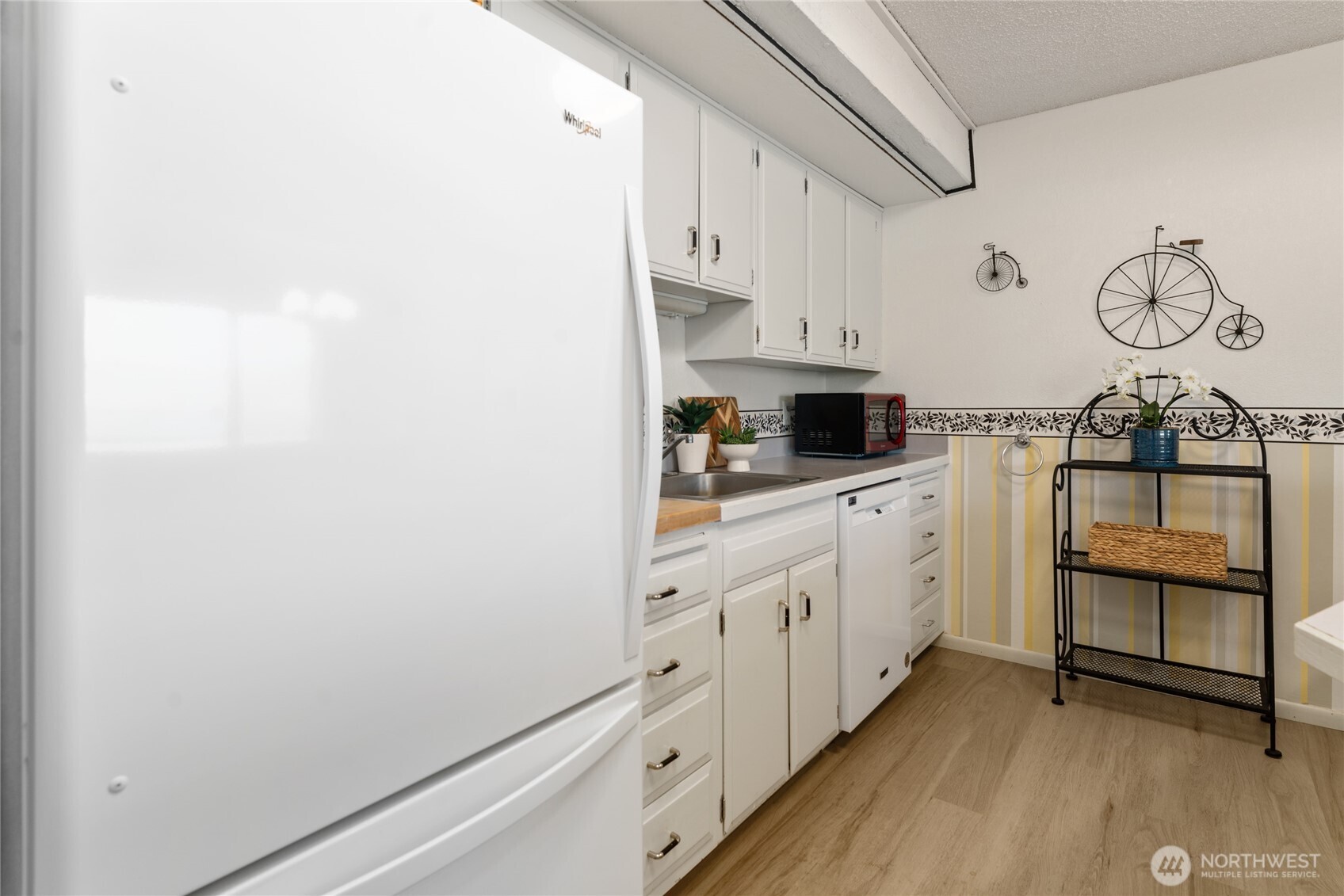 Kitchen view with new refrigerator.