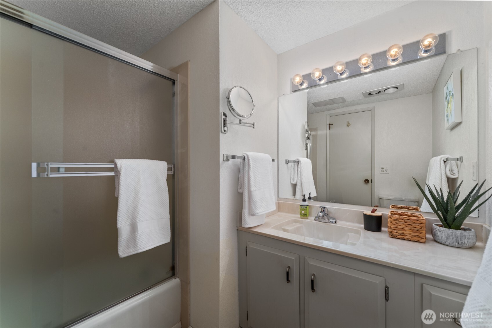Bathroom 1 with bath and shower and large vanity.
