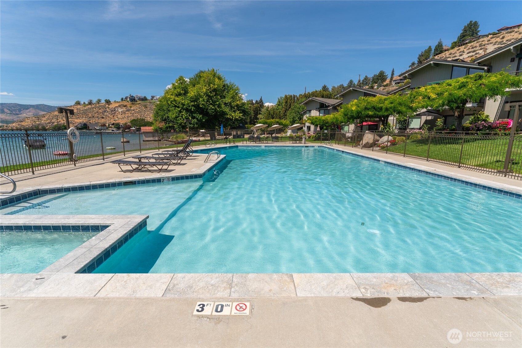 View of Olympic sized pool and attached hot tub.