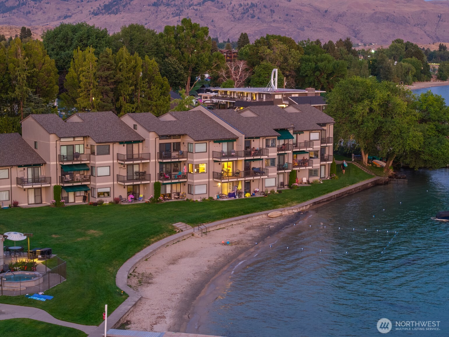 Aerial view of Spader Bay property with grassy lawn, sandy beach and waterfront.
