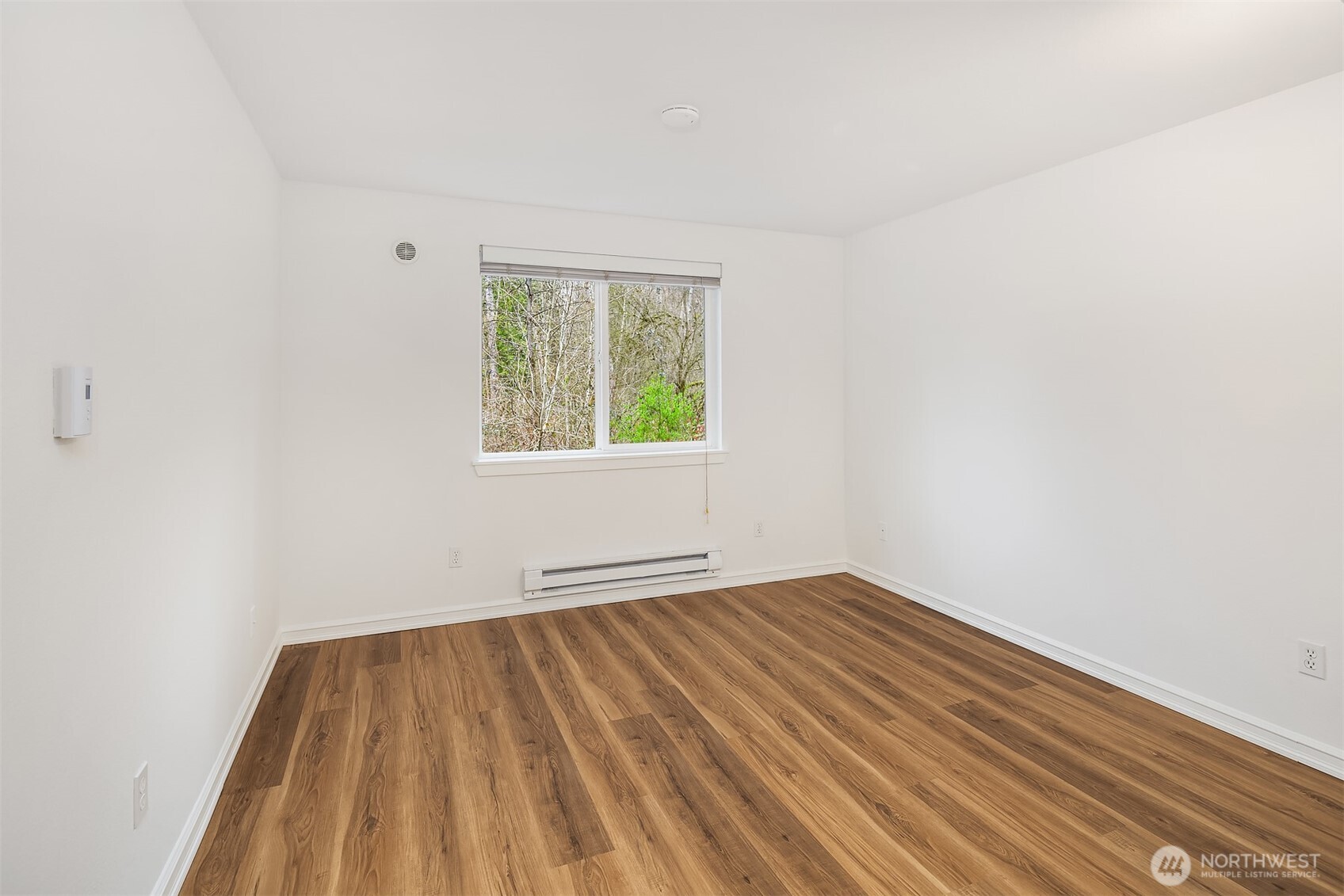 One of the two roomy bedrooms overlooks the peaceful preserved woodland.  New hard surface LVT flooring.