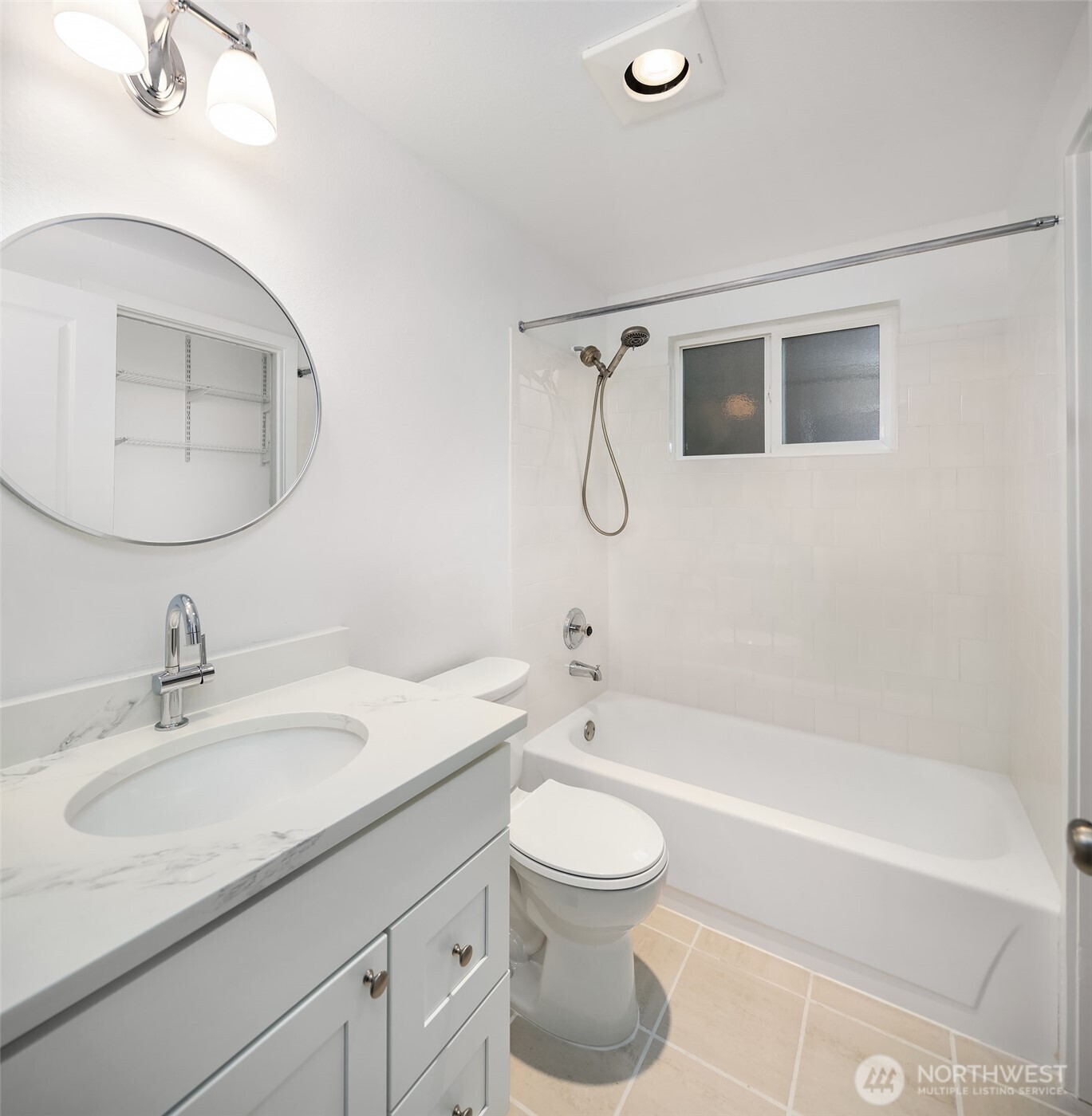 The bathroom includes ceramic tile tub/shower surround and ceramic tile floor.  New cabinet, sink, quartz countertop and toilet.  Bath window opens for lots of fresh air!