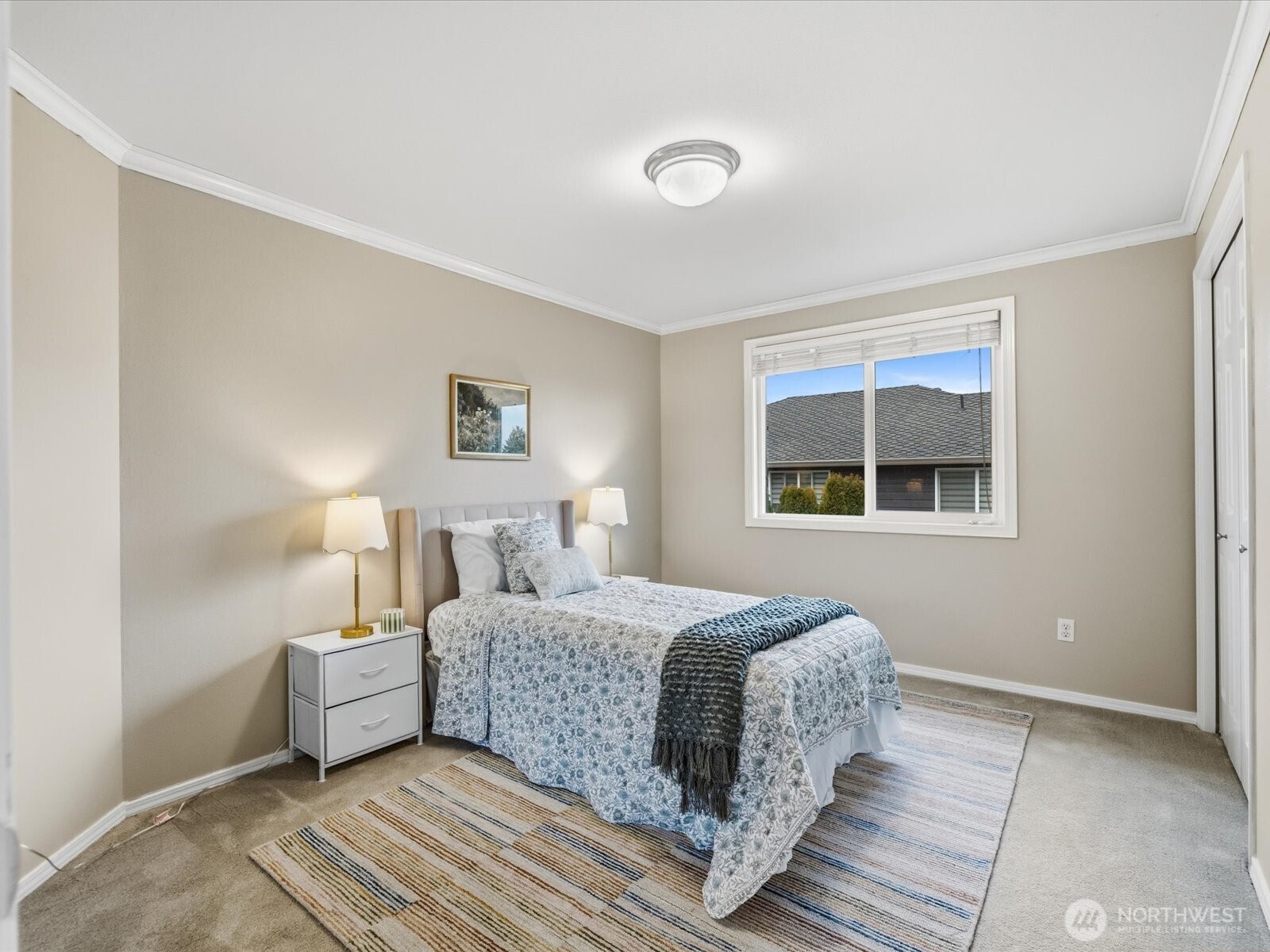 Spacious walk in closet with versatile built in storage.