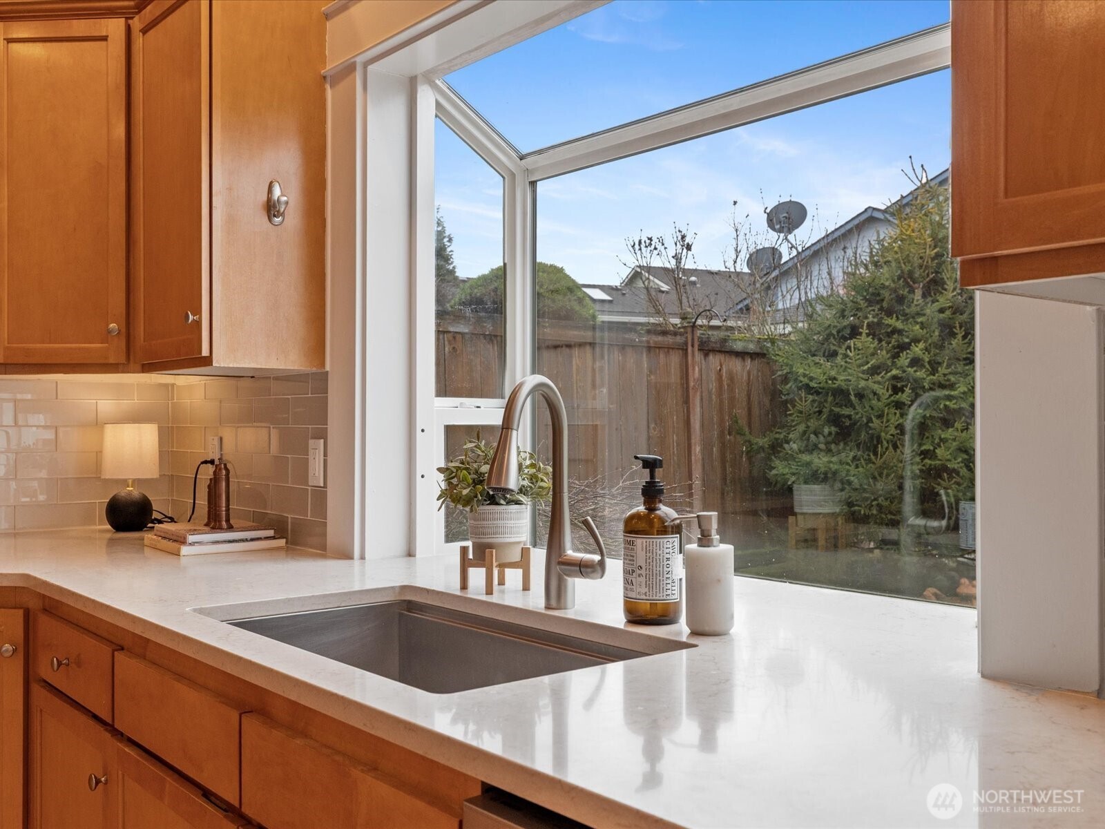 Equipped with Bosch double oven, Bosch range, and Bosch dishwasher, and a large central island.