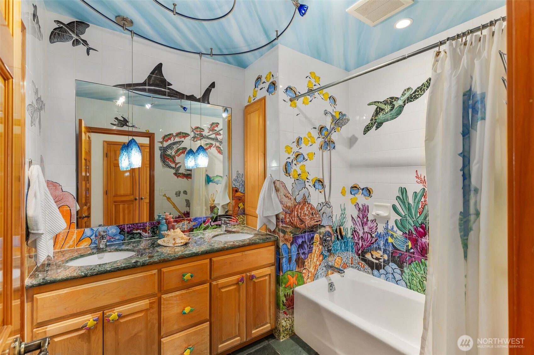Under the Sea. This nautical inspired bathroom is one of a kind. The original owners hired a professional painter to hand paint part of this nice-sized bathroom.