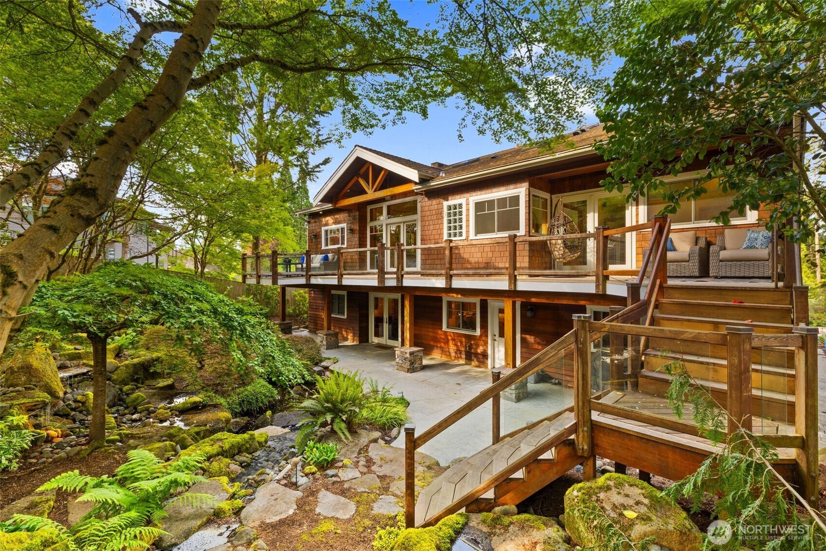 This fascinating backyard will have your friends and anyone who visits in awe. Covered lower outdoor space, a full length rear elevated deck with plenty of room for your furniture, and a breathtaking yearly view.