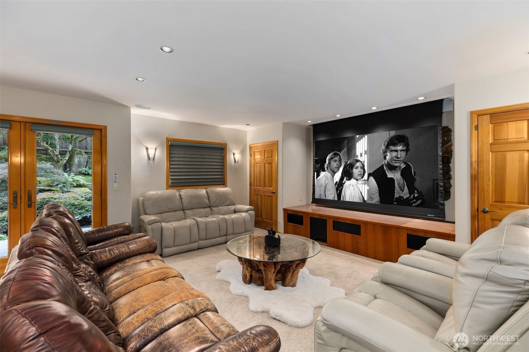 This theater room fits 6-8 seats comfortably, has a drop down screen and a set of French doors out to your outdoor space. Popcorn anyone?