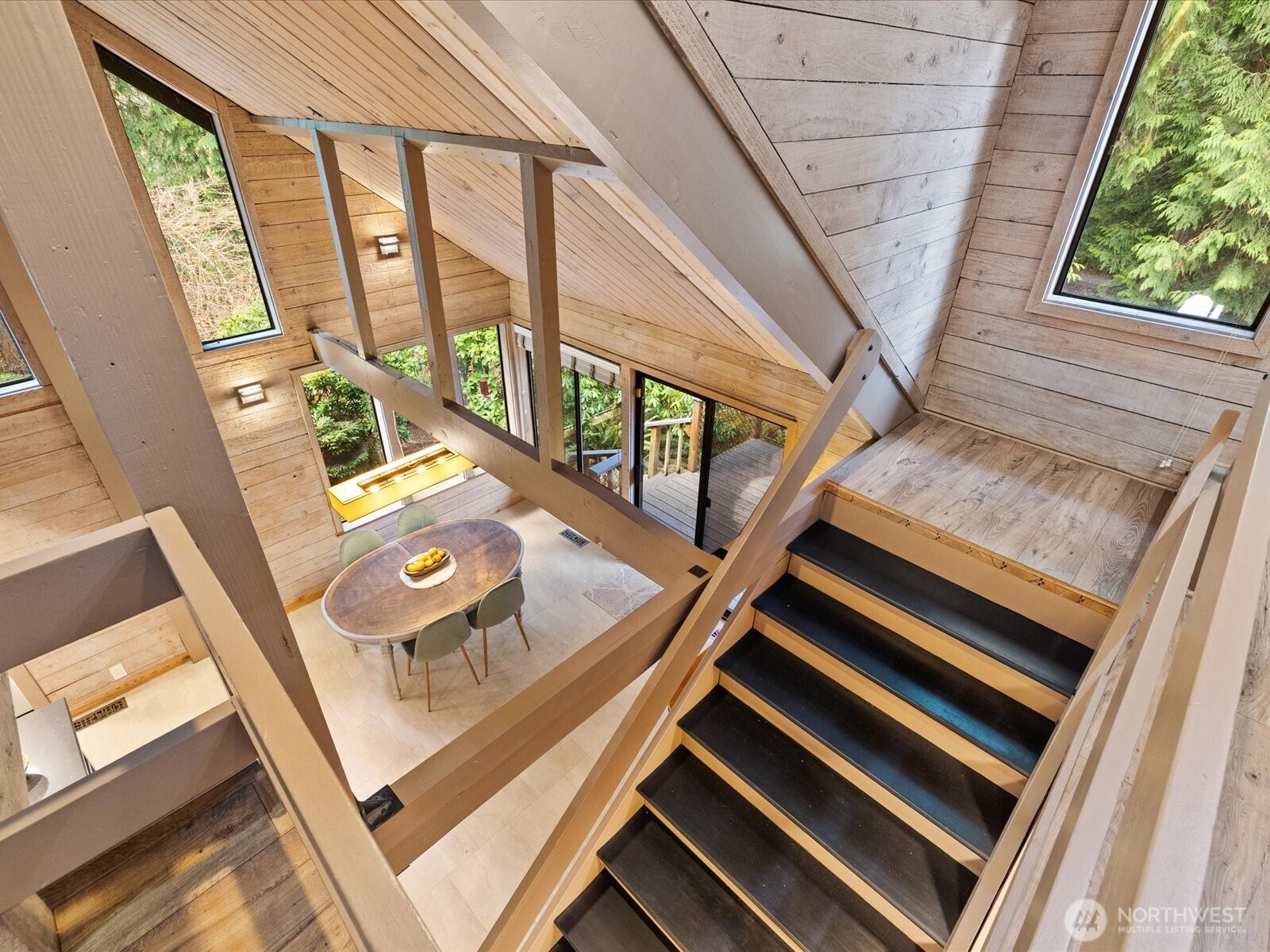 View from 2nd story down into dining space off kitchen. Lots of windows here to bring in natural light.