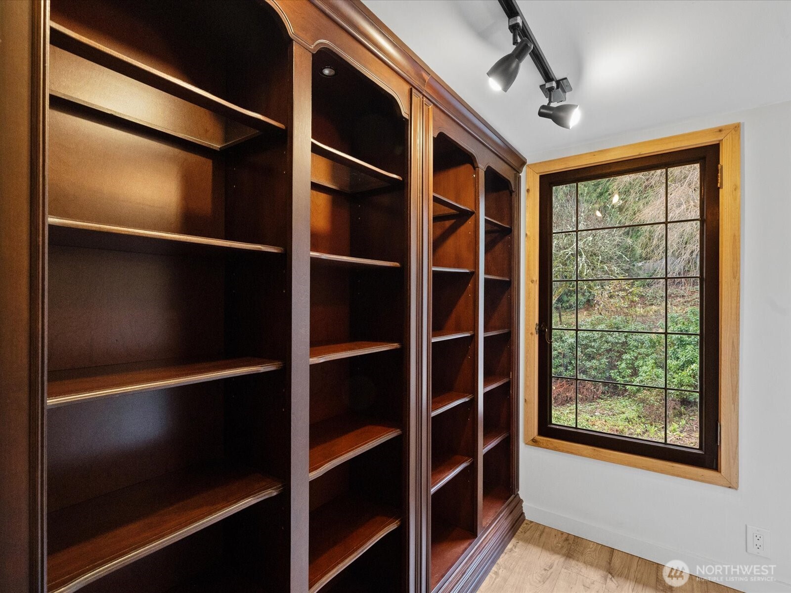 Built in shelving & historic original Seattle Times building window that overlooks lush gardens.