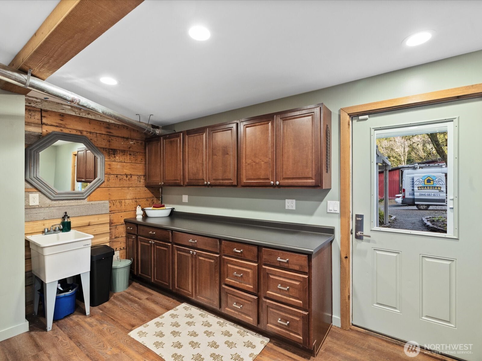 Mudroom with cabinetry and countertops for easy storage.
