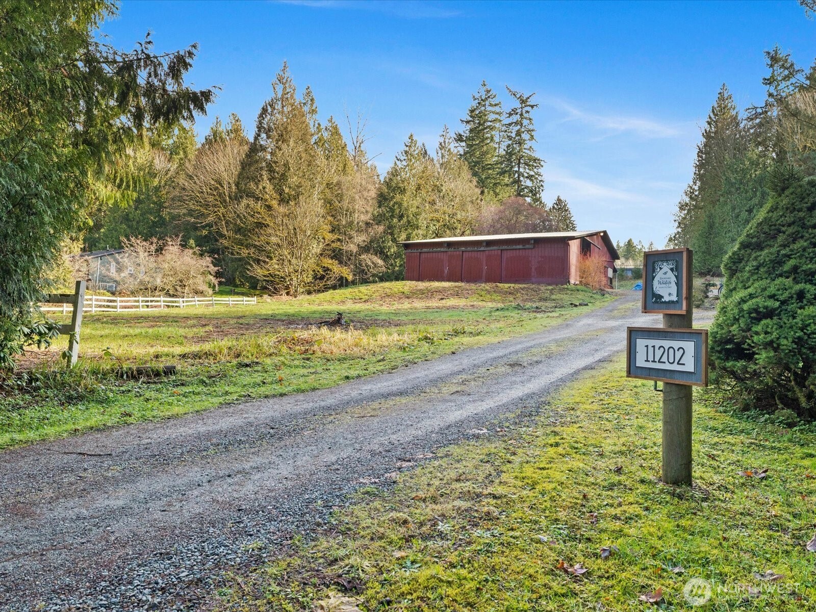 Almost 2.5 acres of lush gardens, fruit trees, raspberry & blueberry bushes, pastures & barn.