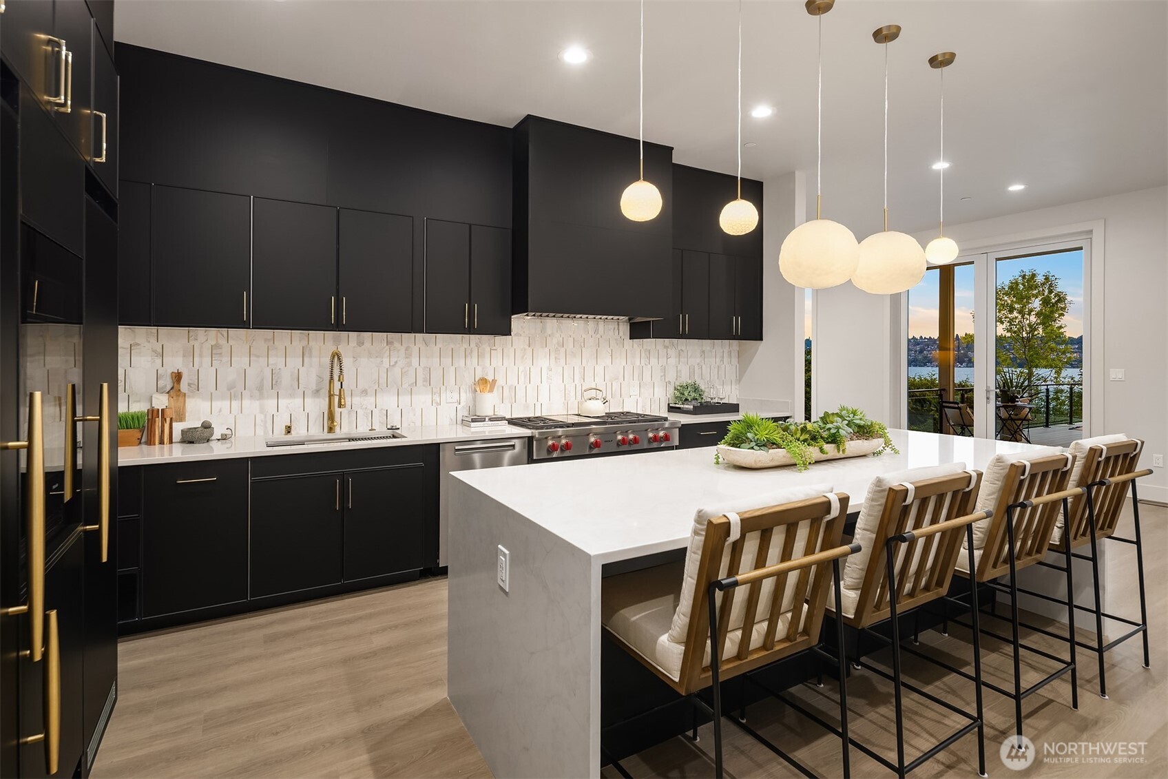 Cook and entertain with inspiring lake views, framed by the kitchen's sleek design and expansive sliding doors