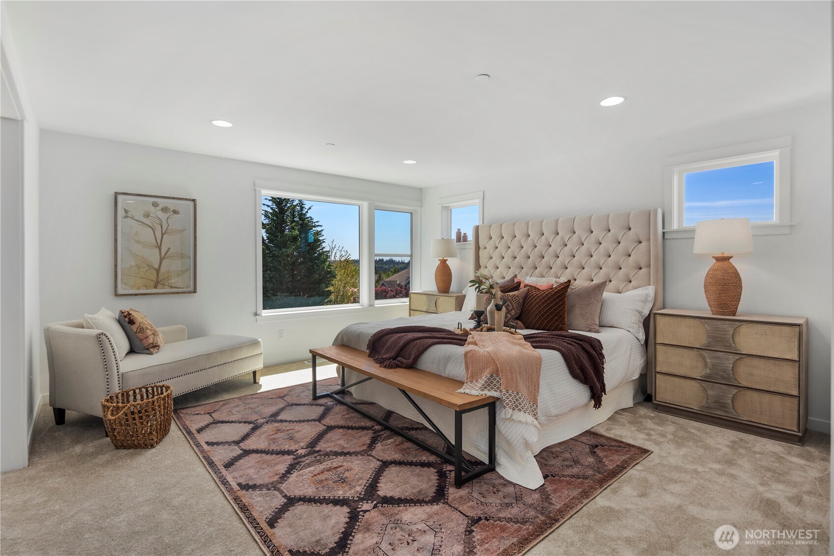 Primary Bedroom: The spacious primary retreat offers an airy layout with large windows that frame natural light throughout the day. Plush carpeting and a versatile sitting area make this room both functional and luxurious, perfect for unwinding in comfort.  Staged photos are of the model home of the same floorplan within the Foxmoore community and are for visualization purposes only. Colors, finishes, and layout can and will vary.