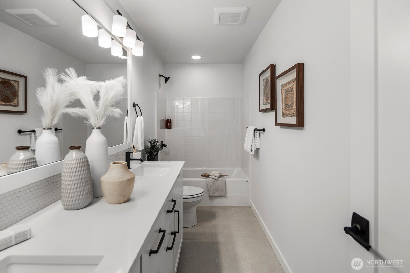 Full Bathroom: Upstairs bathroom with dual-sink vanity, modern fixtures, and a full tub/shower combo. Clean lines and bright finishes create a comfortable and stylish space.  Staged photos are of the model home of the same floorplan within the Foxmoore community and are for visualization purposes only. Colors, finishes, and layout can and will vary.