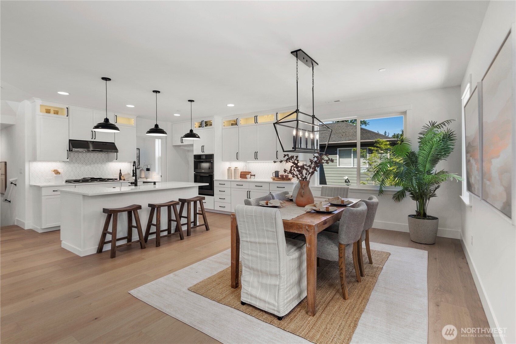 Kitchen & Dining: Bright and open kitchen with a large center island, quartz countertops, and abundant cabinetry paired with modern pendant lighting. The adjacent dining area enjoys oversized windows for natural light, creating an inviting space to gather and entertain.  Staged photos are of the model home of the same floorplan within the Foxmoore community and are for visualization purposes only. Colors, finishes, and layout can and will vary.