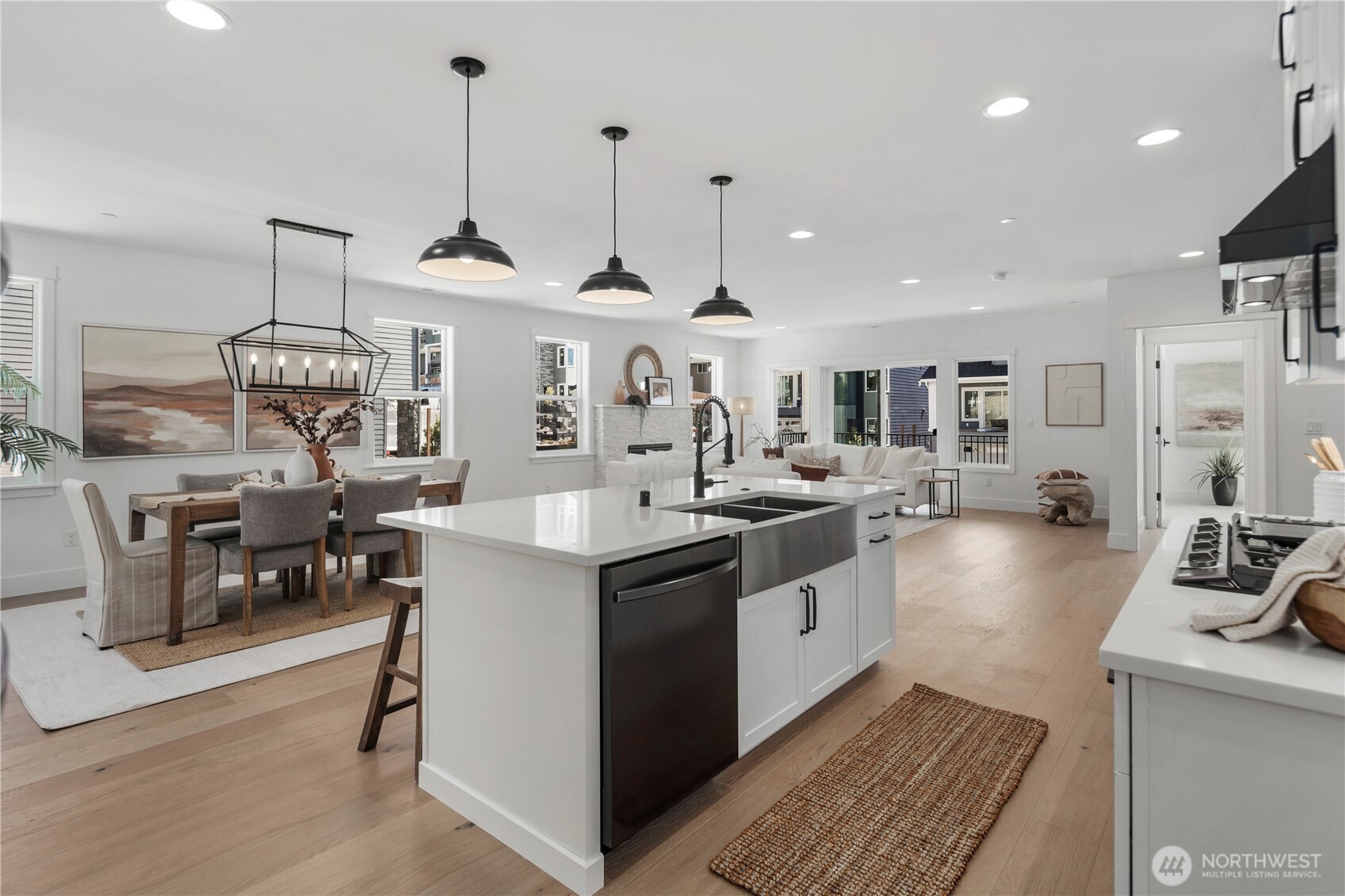 Kitchen & Living Flow: Expansive island with farmhouse sink and modern fixtures overlooks the dining and great room. This open-concept design highlights natural light and creates effortless flow for entertaining or quiet evenings at home.  Staged photos are of the model home of the same floorplan within the Foxmoore community and are for visualization purposes only. Colors, finishes, and layout can and will vary.
