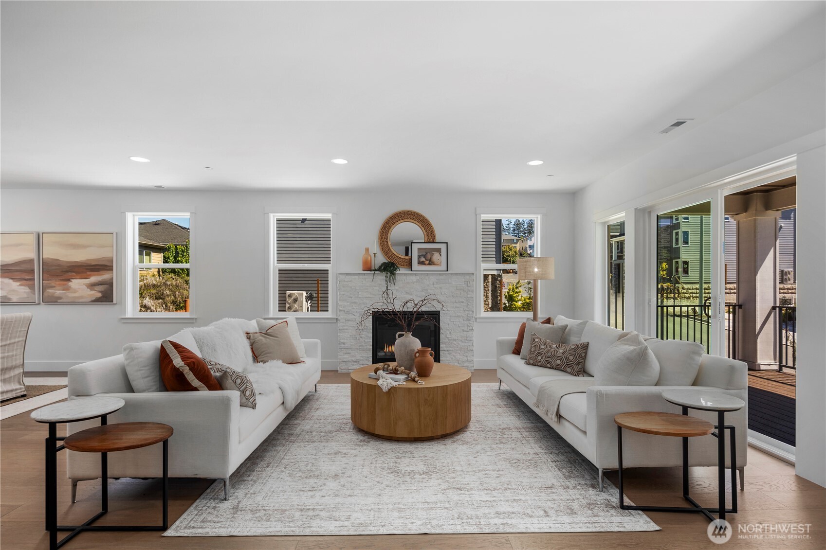 Great Room: Spacious great room with a modern tile-surround fireplace and large windows filling the room with light. The open floor plan connects to the kitchen and dining spaces, ideal for gatherings or relaxing evenings.  Staged photos are of the model home of the same floorplan within the Foxmoore community and are for visualization purposes only. Colors, finishes, and layout can and will vary.