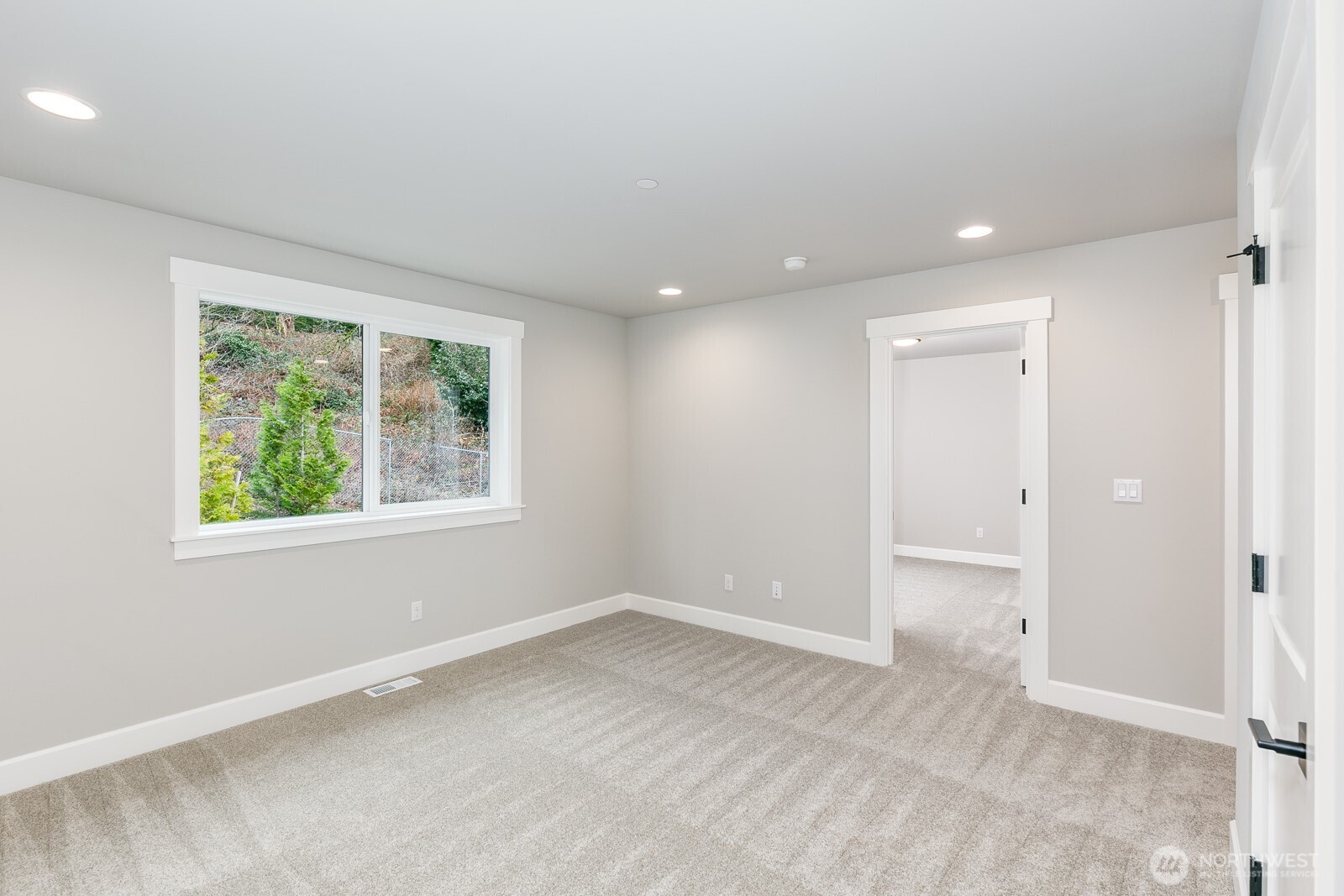 The spacious upper floor Primary Ensuite offers sweeping treetop views and sunsets.