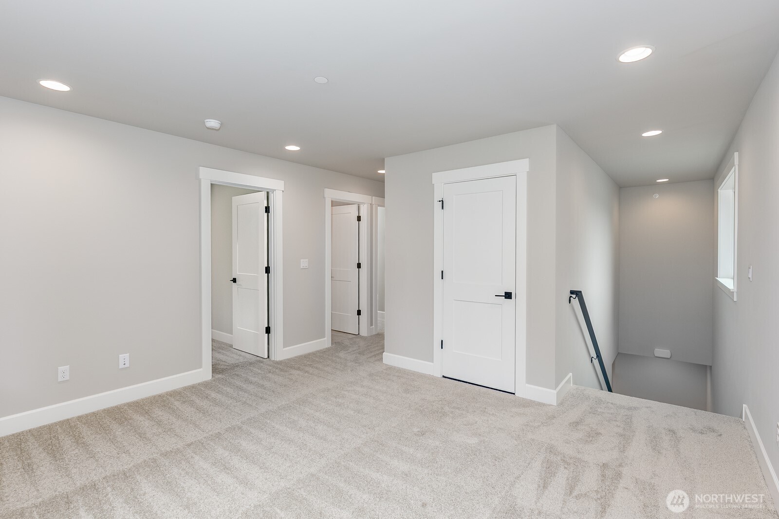 The deluxe laundry room is complete with a sink, tile floors and 2 walls of cabinets.